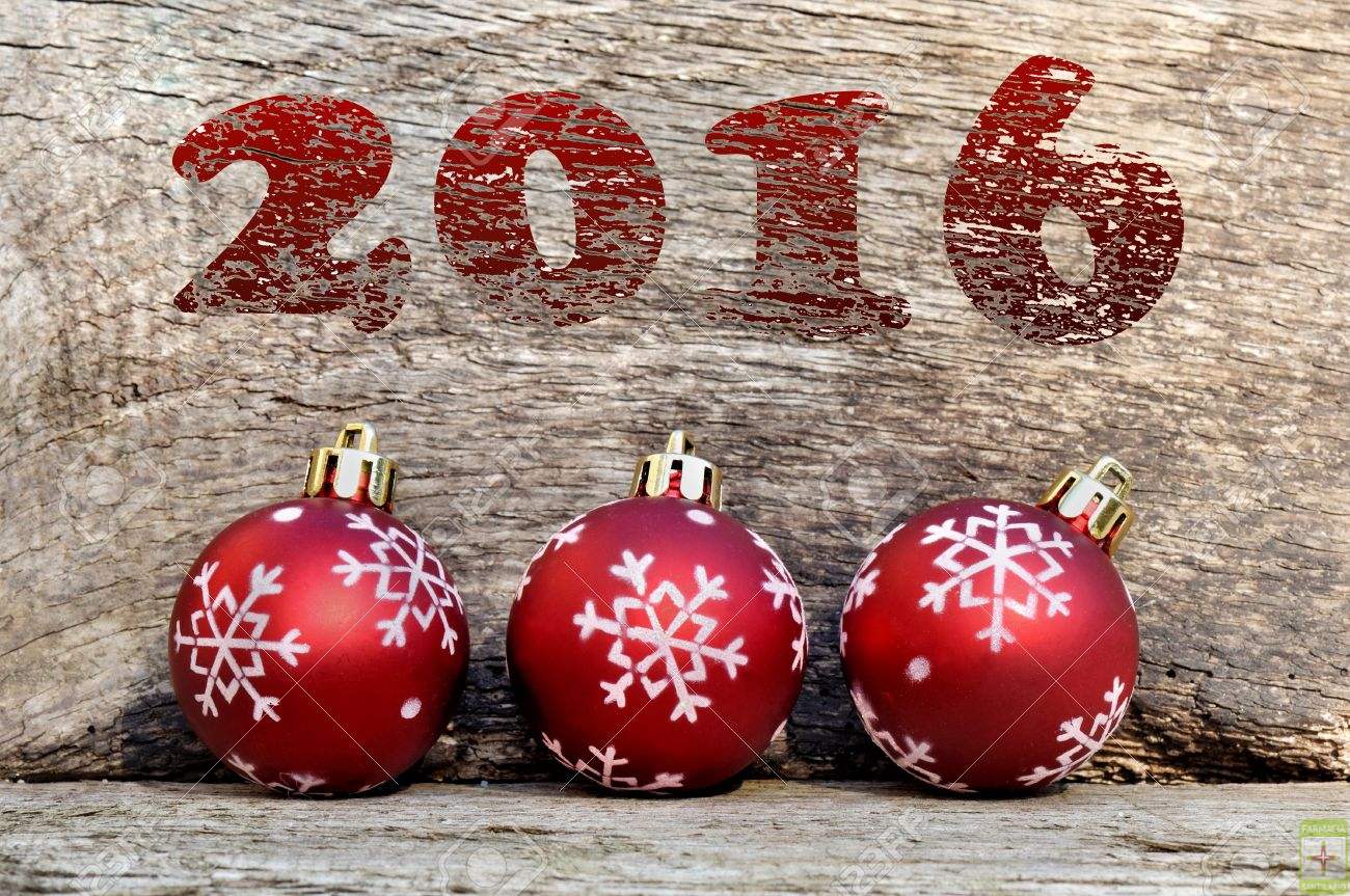 2016 red and christmas balls on wooden background